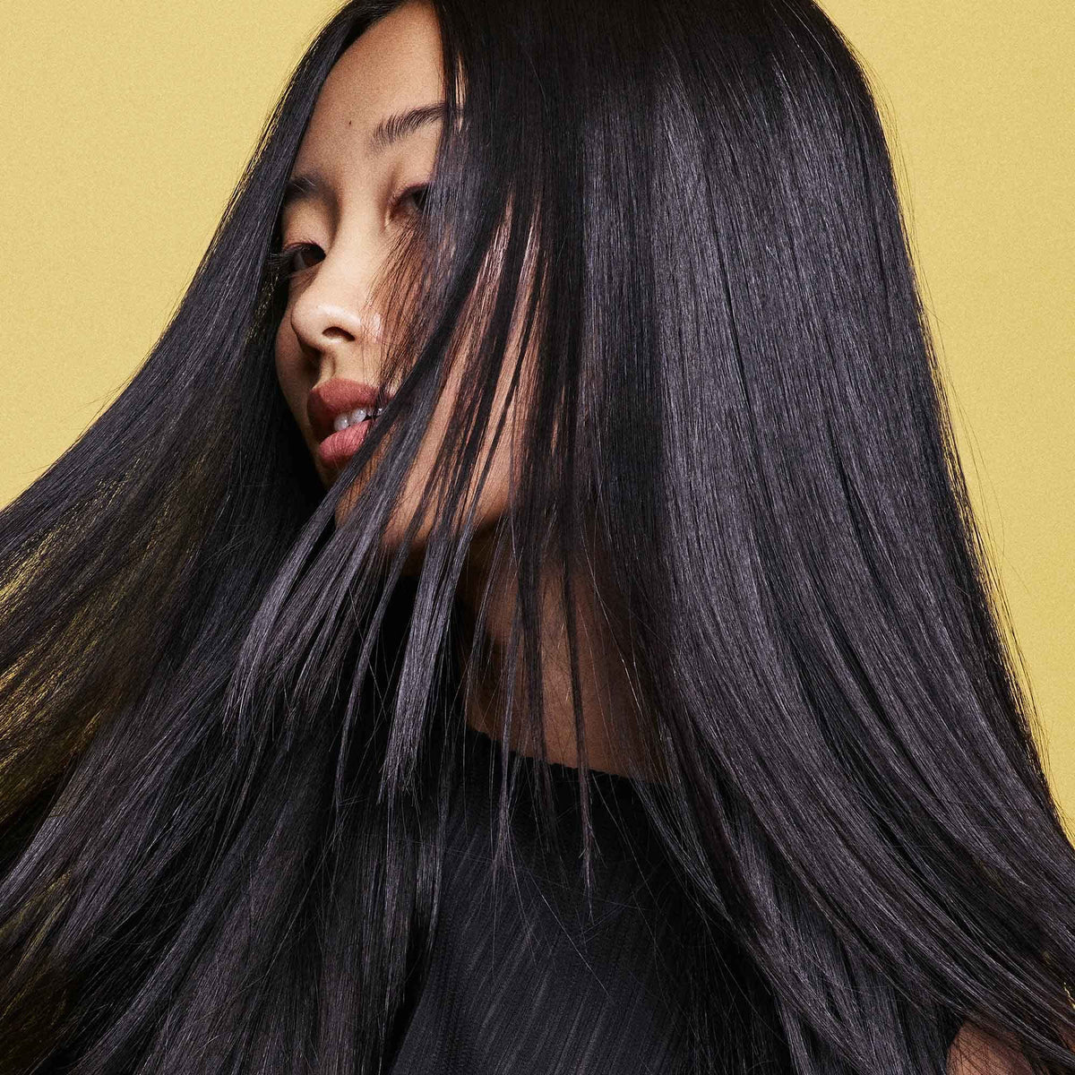 ORIBE botanical ingredients flatlay showing plant-based strengthening benefits