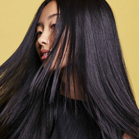 ORIBE botanical ingredients flatlay showing plant-based strengthening benefits
