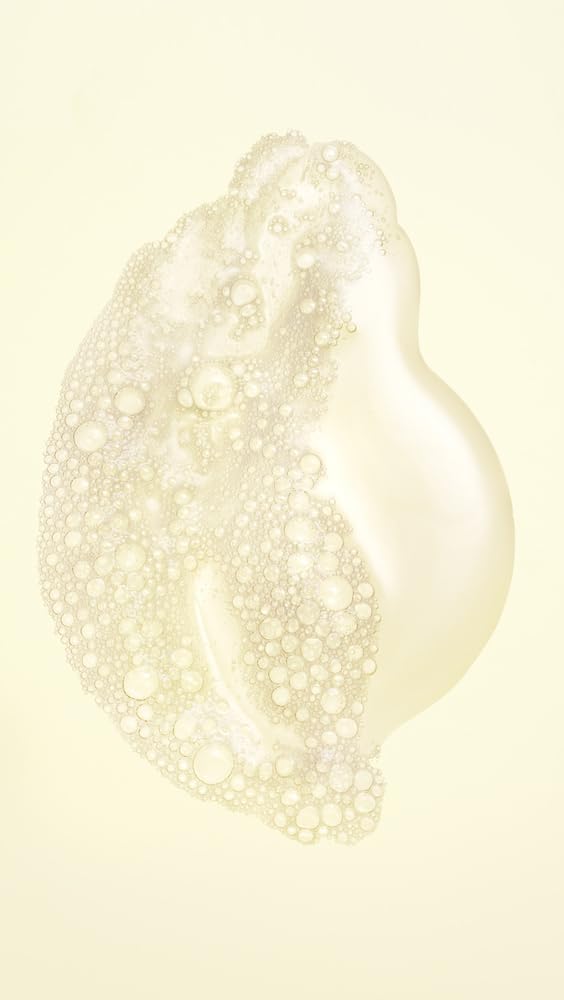 Oribe shampoo lather closeup demonstrating rich foam and gentle cleansing action