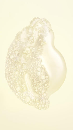 Oribe shampoo lather closeup demonstrating rich foam and gentle cleansing action