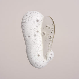 Oribe pump and cap detail highlighting premium packaging and usability