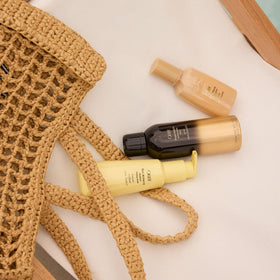 Oribe Matte Waves styled model on beach showing long-lasting beachy waves benefit
