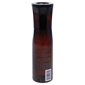Oribe Maximista in-hand application demonstrating spray texture and quick root lift benefit