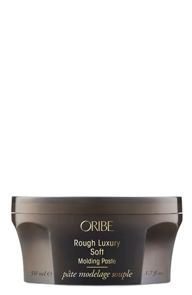Oribe jar front view showing label and compact size, brand quality visible