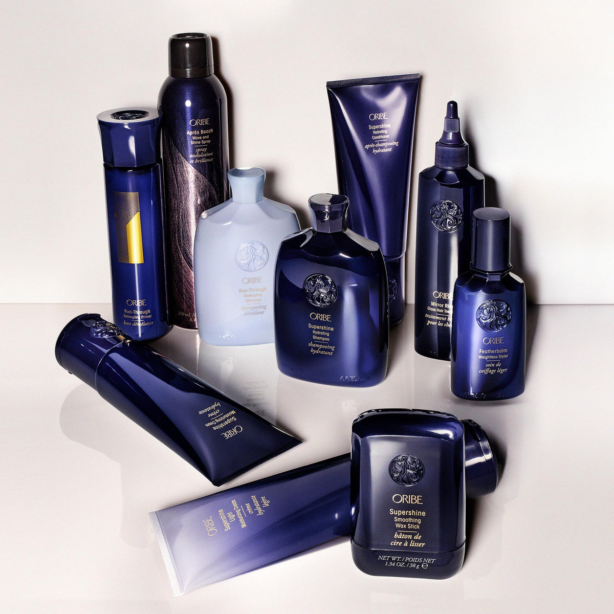 ORIBE bottle on bathroom shelf styled with towels to show luxury routine benefit
