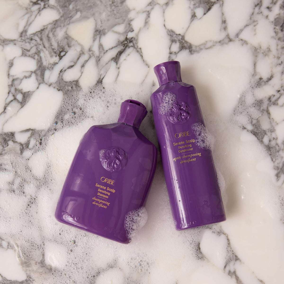 Oribe Serene botanical ingredients styled together showing pea sprout and red clover benefit