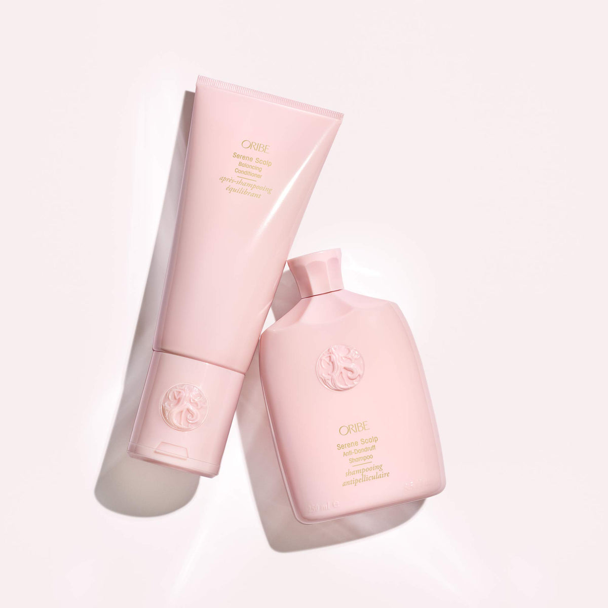 Oribe Serene Scalp bottle held in hand to show 8.5oz size and travel-friendly benefit