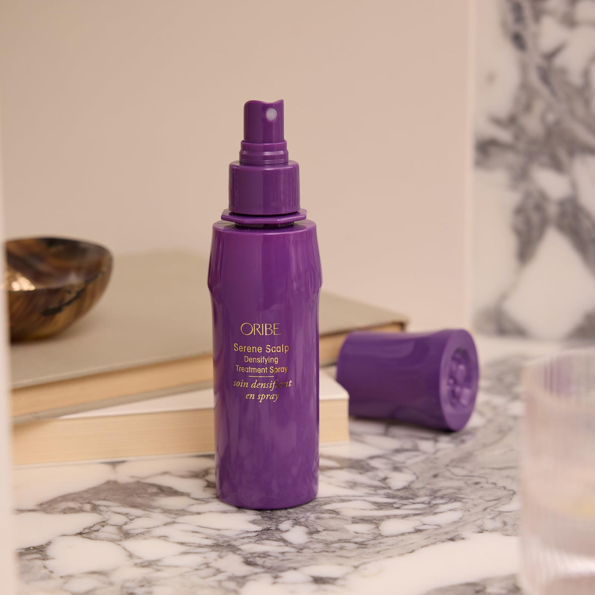 ORIBE product label close-up highlighting key strengthening ingredients