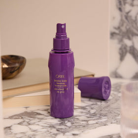 ORIBE product label close-up highlighting key strengthening ingredients