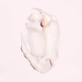 Oribe Serene Scalp dispensing foam from pump illustrating easy application benefit