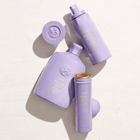 oribe bottle beside everyday items for scale and travel-friendly benefit