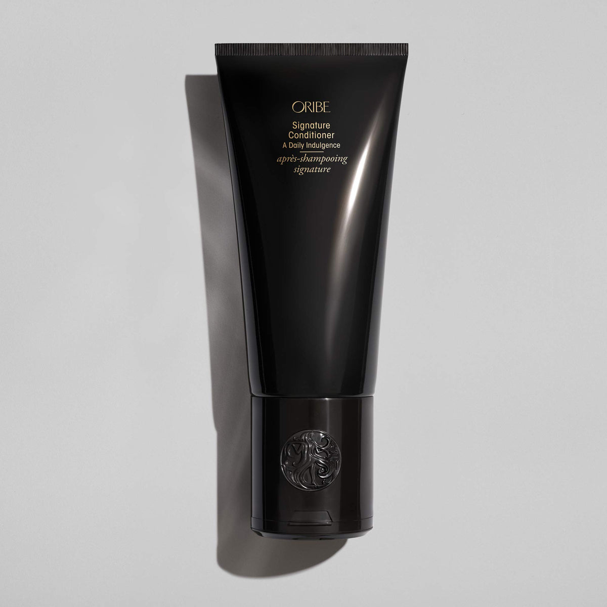 Oribe conditioner cream texture closeup showing smooth consistency for easy detangling