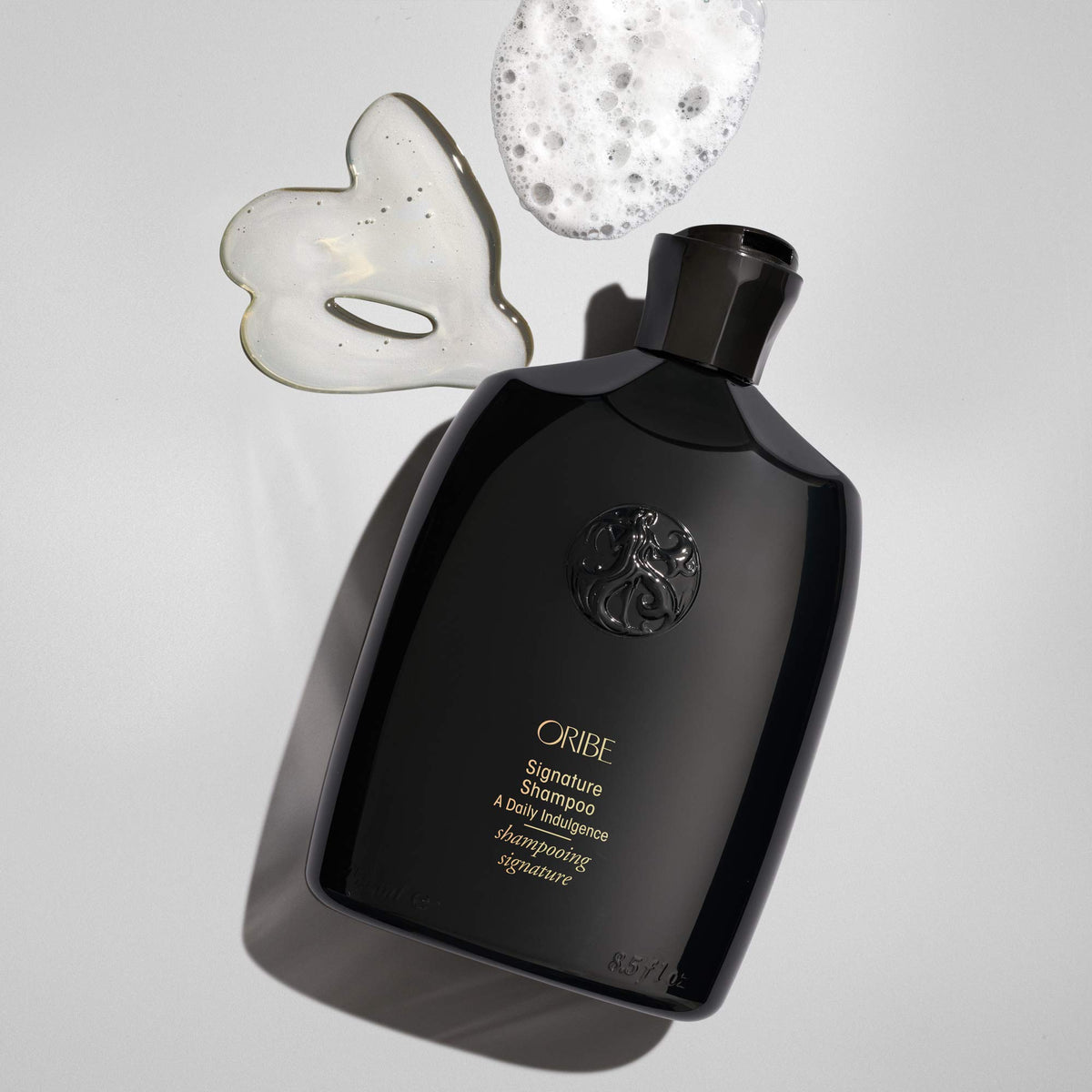 Oribe signature shampoo creamy texture closeup showing rich moisturizing feel