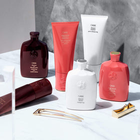 ORIBE Silverati being applied to silver hair in shower for smoother detangling