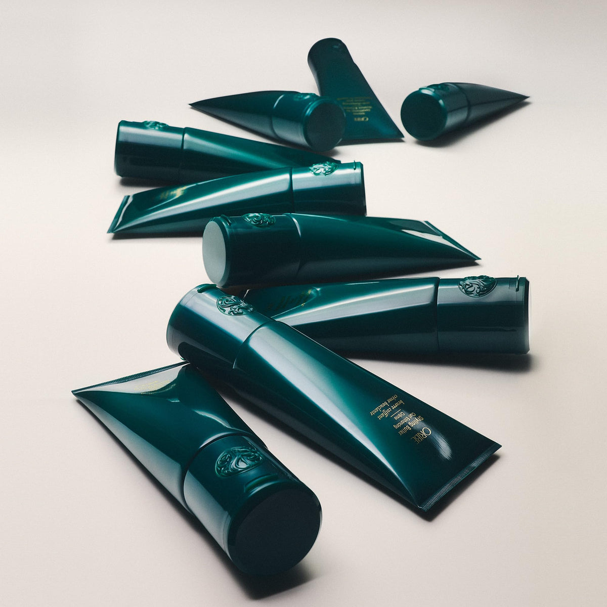 Oribe applying cream to coily hair to show curl definition and frizz control