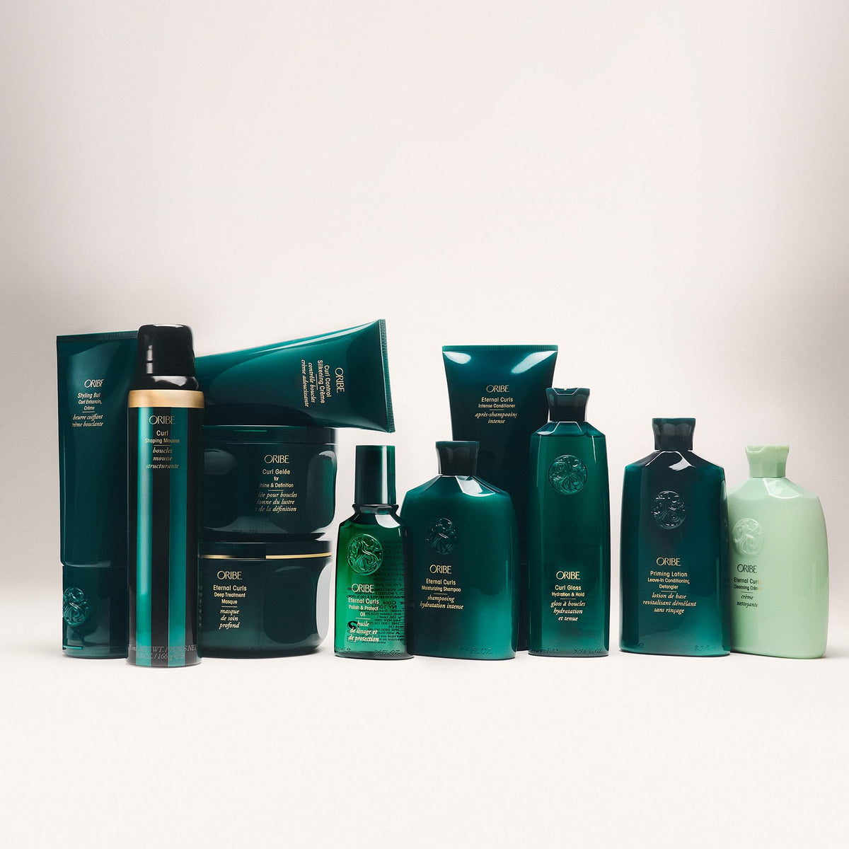Oribe lifestyle shot of model with defined curls showcasing natural bounce