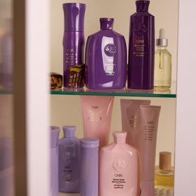 Oribe Serene shampoo being applied by stylist in salon showing professional-use benefit