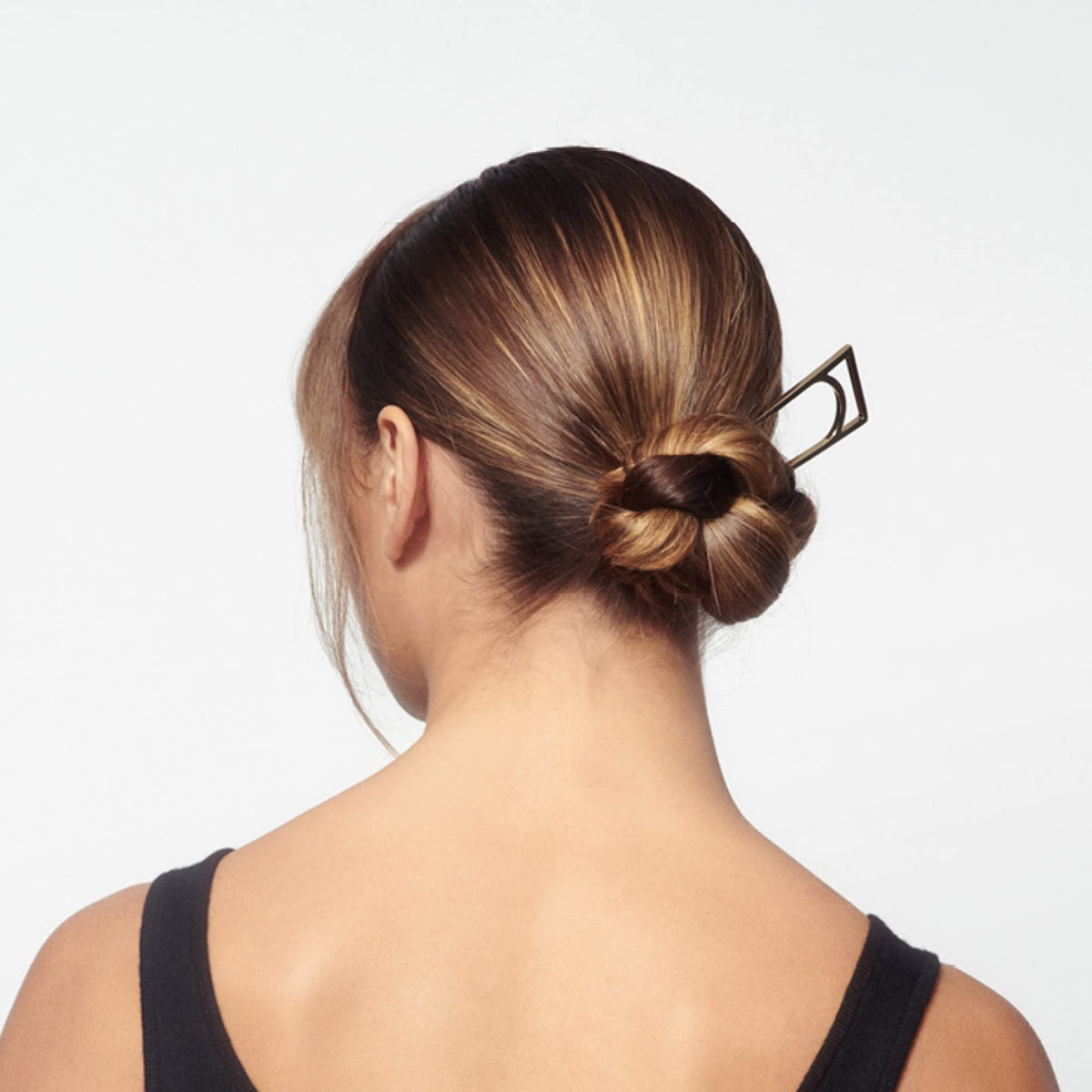 Oribe Superfine 9 oz size comparison beside common objects showing portable salon-sized convenience