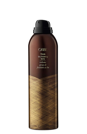 Oribe can held in hand to display the 7 oz size and portability
