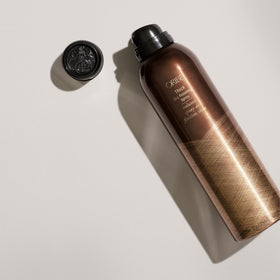 Oribe misting onto hair highlighting added thickness and texture