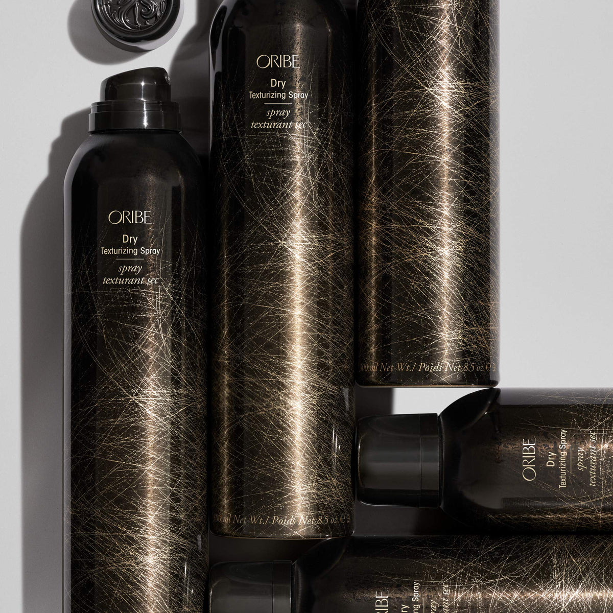 Oribe spray inside a travel bag to show convenience and on-the-go refresh