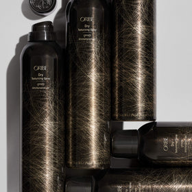 Oribe spray inside a travel bag to show convenience and on-the-go refresh
