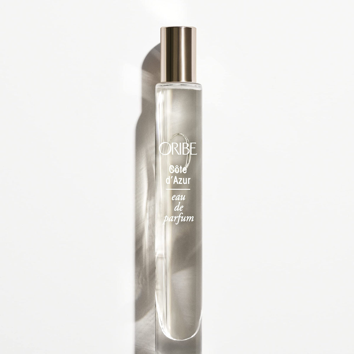 Hand holding ORIBE travel Côte d'Azur to show scale and convenience for on-the-go refreshes