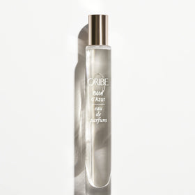 Hand holding ORIBE travel Côte d'Azur to show scale and convenience for on-the-go refreshes