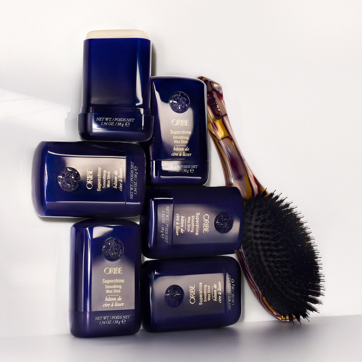 Côte d’Azur scent visual next to Oribe Supershine wax stick evoking fresh fragrance