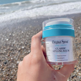 Original Sprout applying balm to damp hair demonstrating smooth styling benefit