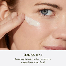 Origins GinZing swatched on hand demonstrating blendable skin tint and instant radiance