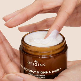 Origins jar open to reveal cream consistency and easy application benefit