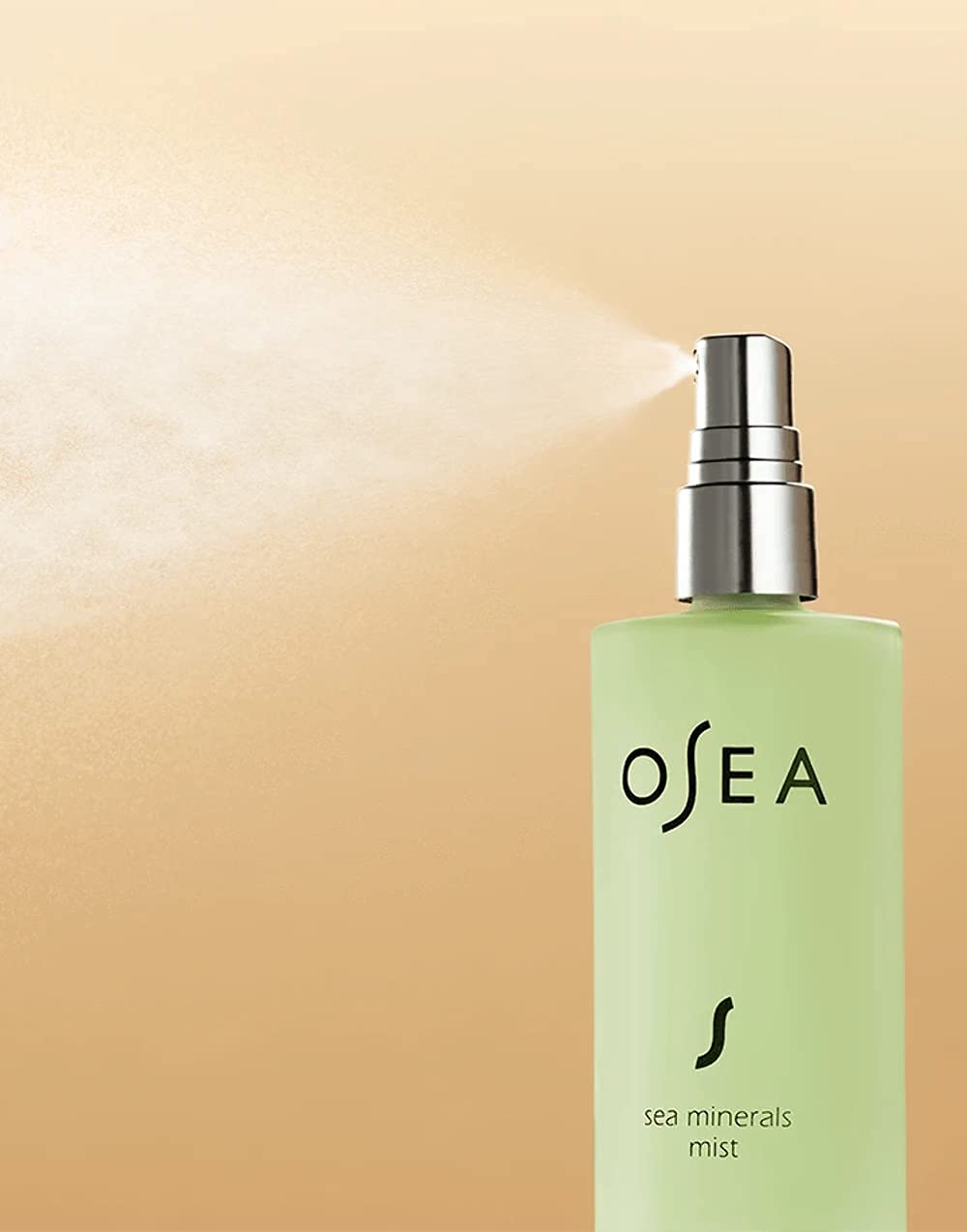 OSEA bottle in hand for scale, travel-friendly size and convenience benefit