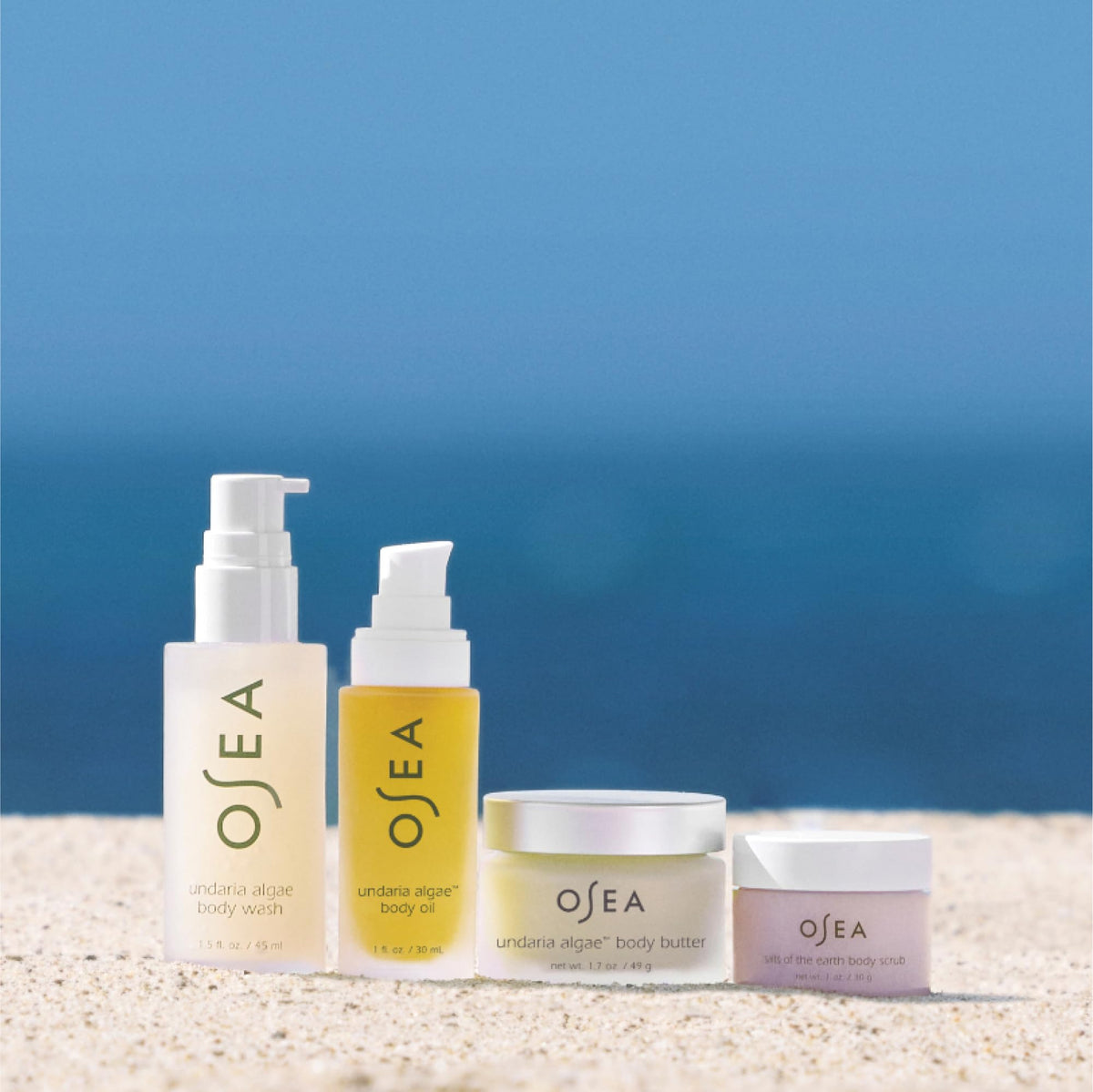 OSEA Salts of the Earth scrub in hand showing exfoliating grains for smoother skin