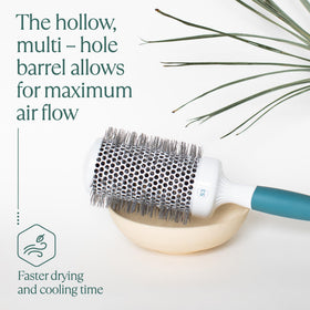Osensia brush in use with blow dryer creating volume and smooth finish