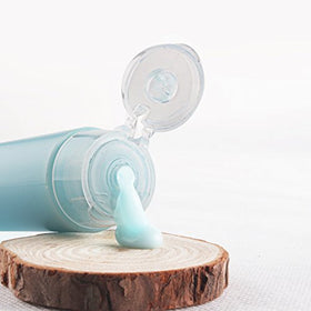 OTO bottle beside ruler showing 30ml scale for compliant travel size