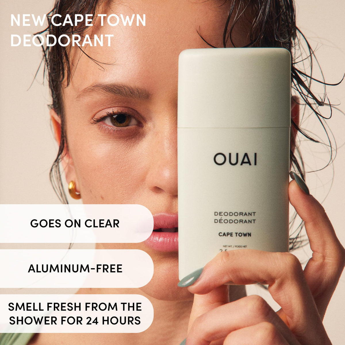 OUAI deodorant held in hand to show 2.5 oz size and travel convenience