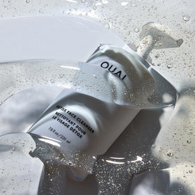 OUAI pouring cleanser into hand demonstrating creamy application and easy rinse