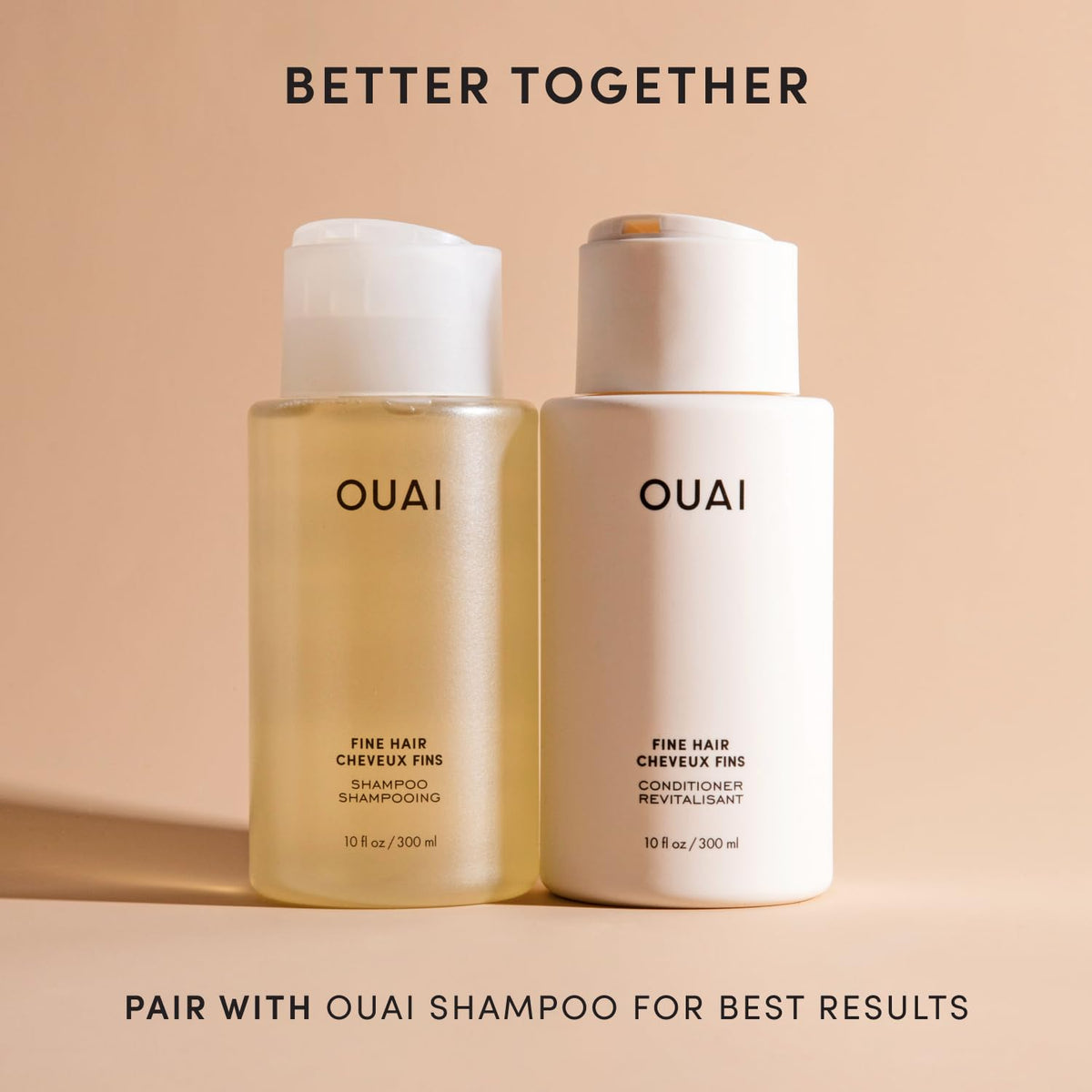 OUAI conditioner held in hand to show 10 oz size and travel-friendly scale advantage