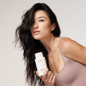 OUAI medium conditioner texture pouring from pouch showing creamy hydrating consistency