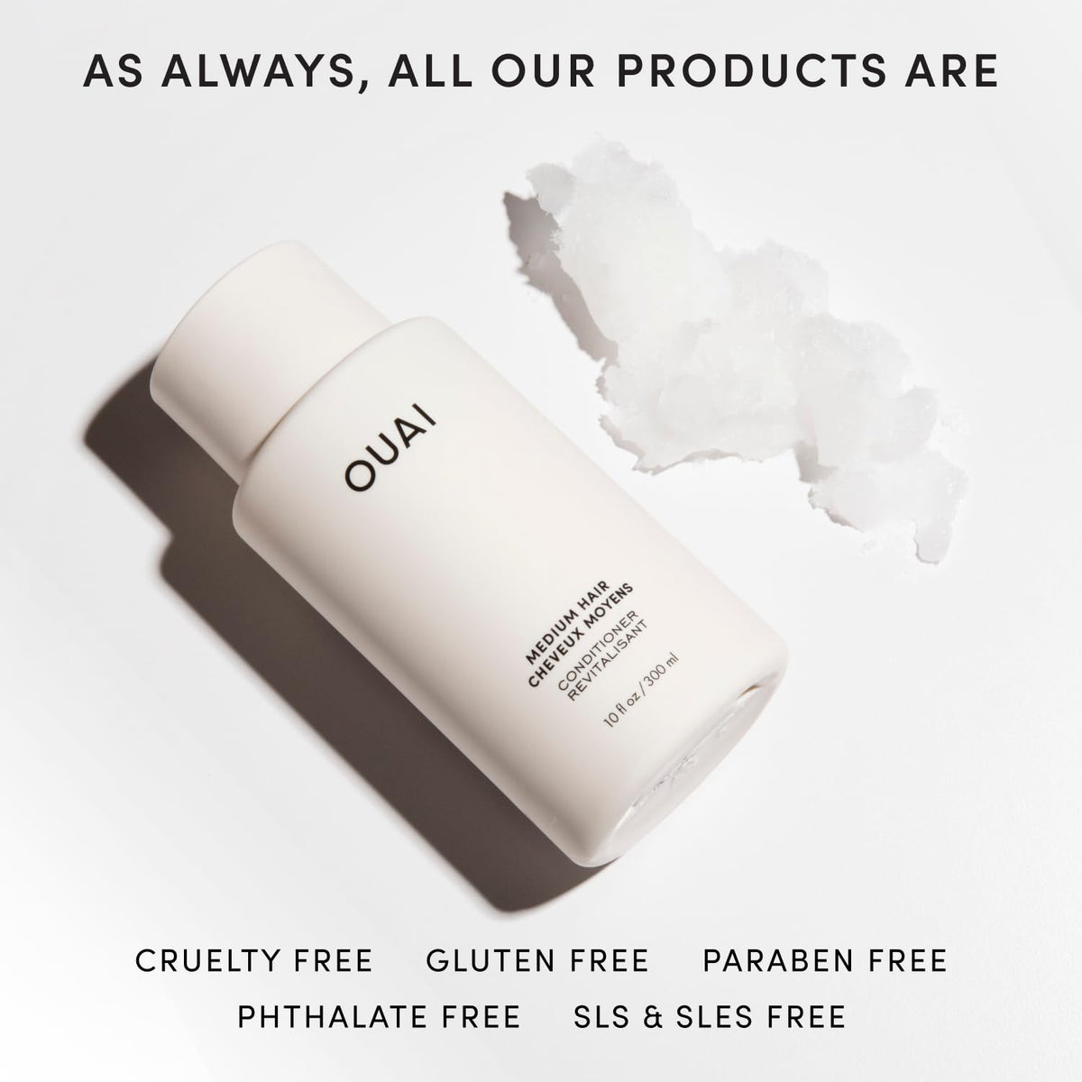 OUAI medium conditioner next to a ruler showing 10 oz size and travel-friendly benefit