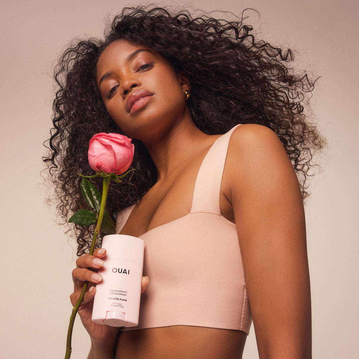 OUAI Melrose Place lifestyle shot of model applying deodorant for confident freshness