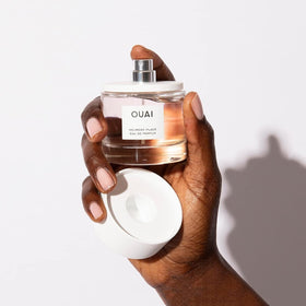 OUAI bottle beside ruler showing 1.7 oz size for travel and portability benefit