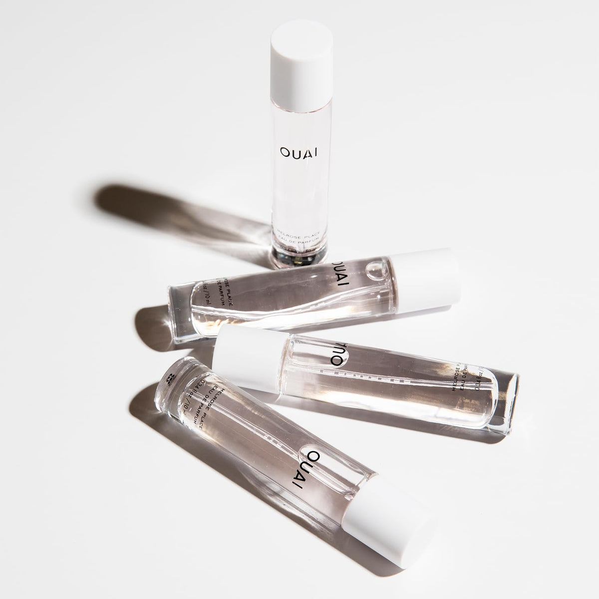 OUAI Melrose Place spray in hand illustrating easy on-the-go refresh benefit