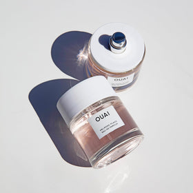 OUAI glass bottle reflection close-up showing luxury finish and shelf appeal