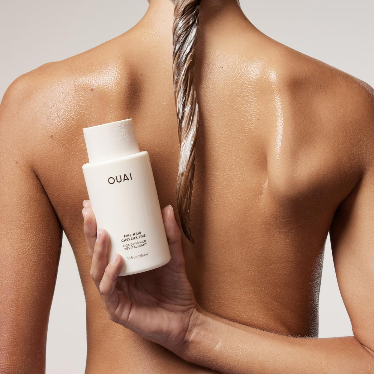 OUAI conditioner being dispensed from pump showing controlled portion and easy use benefit