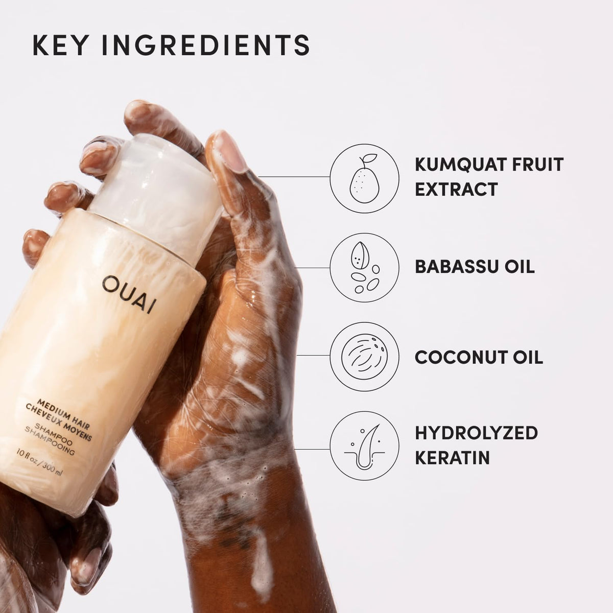 Applying OUAI shampoo in shower demonstrating easy distribution and cleanse benefit