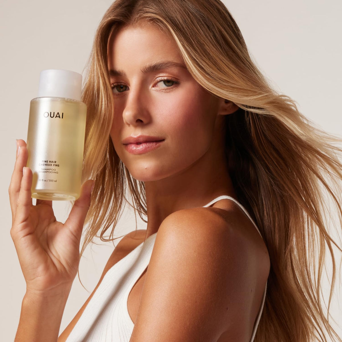 OUAI shampoo creating lightweight lather to demonstrate gentle, volumizing cleanse