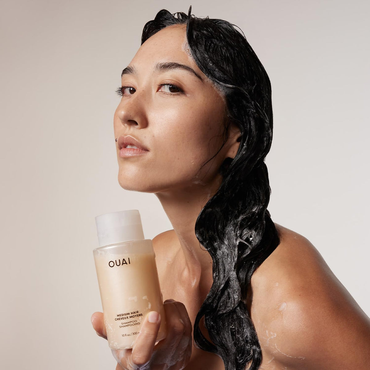 OUAI shampoo foam texture being dispensed illustrating gentle lather benefit