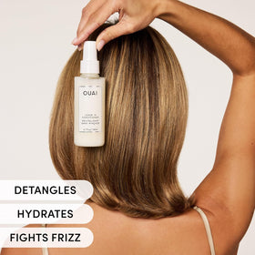 OUAI spray action midair demonstrating fine mist for lightweight coverage